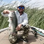 Angler with amazing catch of a great black bass catch at lake Chapala
