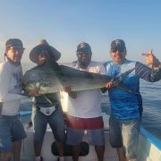 Happy Anglers showing of a beautiful mahi mahi catch